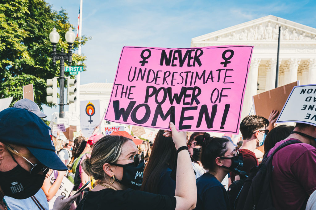 Never underestimate the POWER of WOMEN sign carried by women at Oct. 2. At Pro-Abortion Protest in Washington D.C.