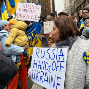 Russia Hands Off Ukraine and Russia Bombing Ukraine. Demonstrators holding signs.