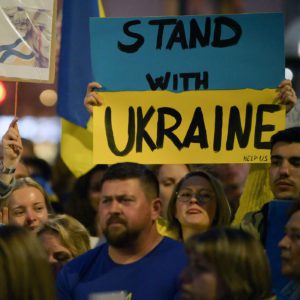 Stand with Ukraine- protestors carrying large signs protesting against Russia's War against Ukraine.